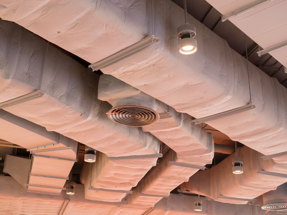 A ceiling filled with numerous pipes and ducts, showcasing a complex network of industrial infrastructure.